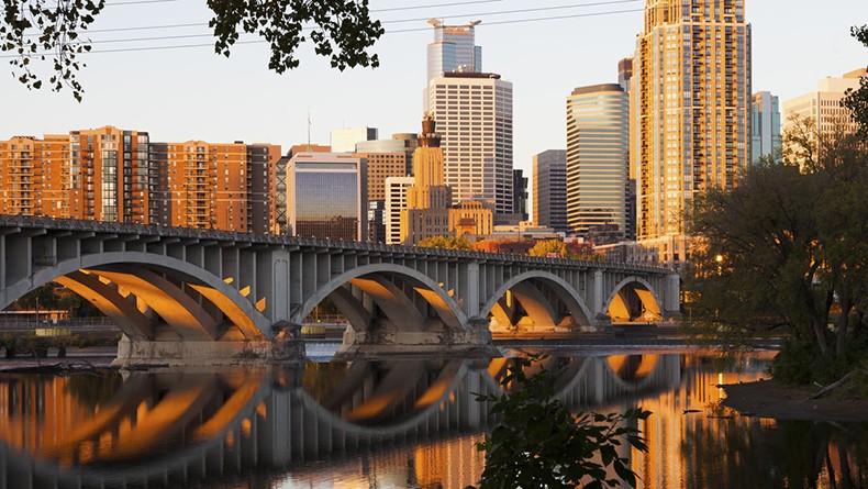 Cityscape and bridge with reflection of bridge in water